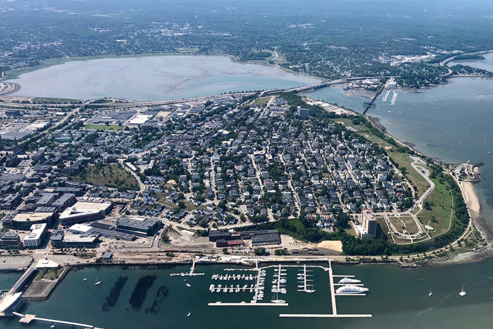 aerial view of buildings next to body of water