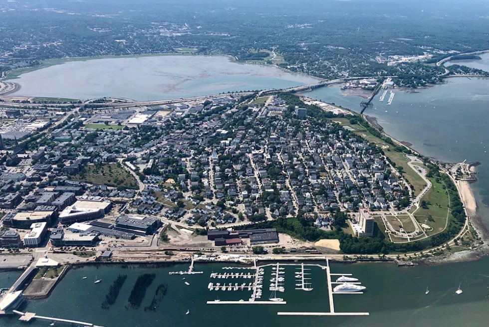 aerial view of buildings next to body of water