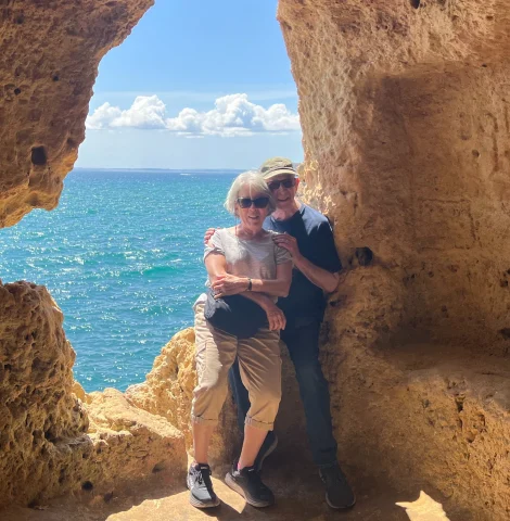 Rita and her husband posing in a cave at Vila Nova de Gaia beach 