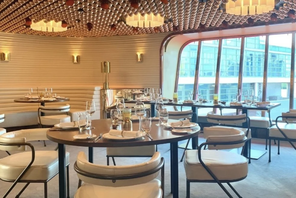 a cruise ship formal dining room with a large window