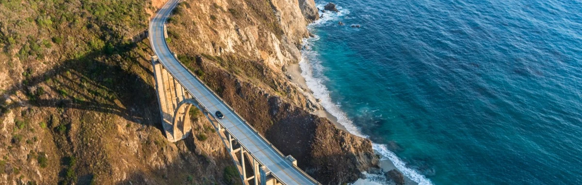 Birdview of Bixby Bridge on PCH highway overlooking the Pacific Ocean and sitting above the Big Sur's oceanside cliffs in Monterey County, CA. 