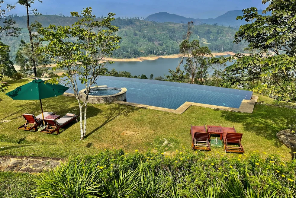 A view from a hotel room with an infinity pool hanging over the mountainside. 