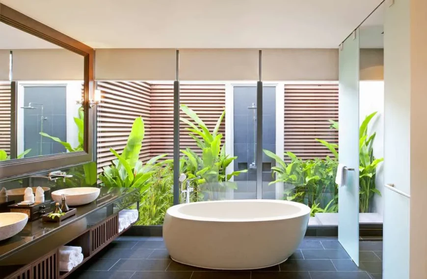 a large white bathtub in a bathroom with floor-to-ceiling windows