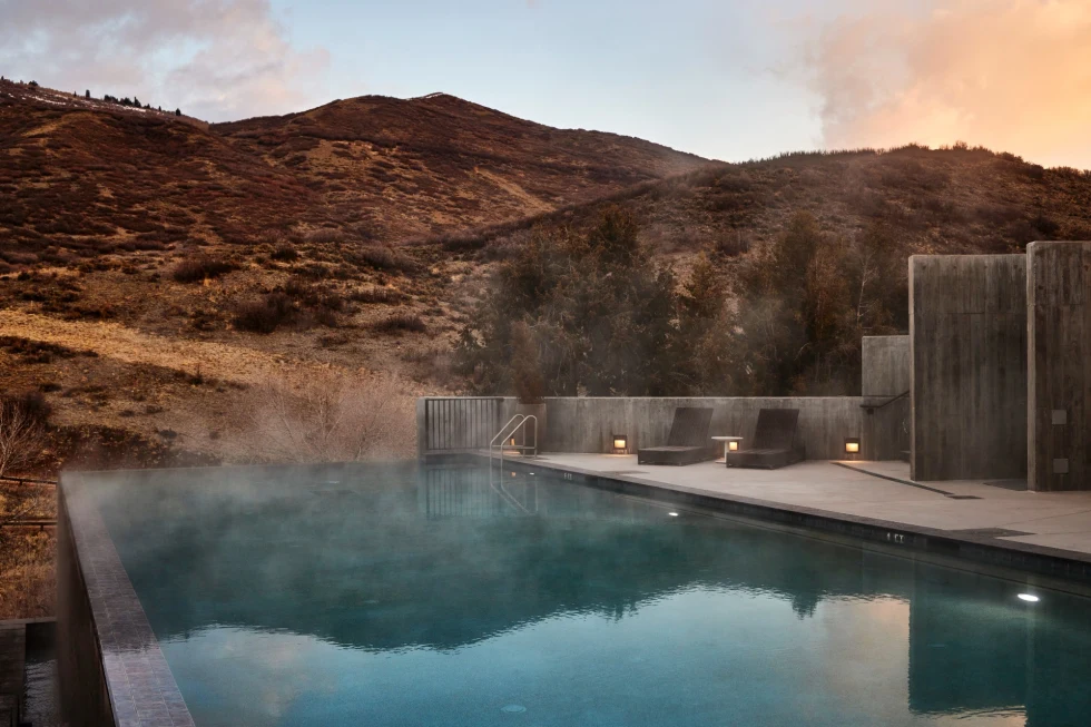 A sleek infinity pool with steam rising from it, at The Lodge at Blue Sky
