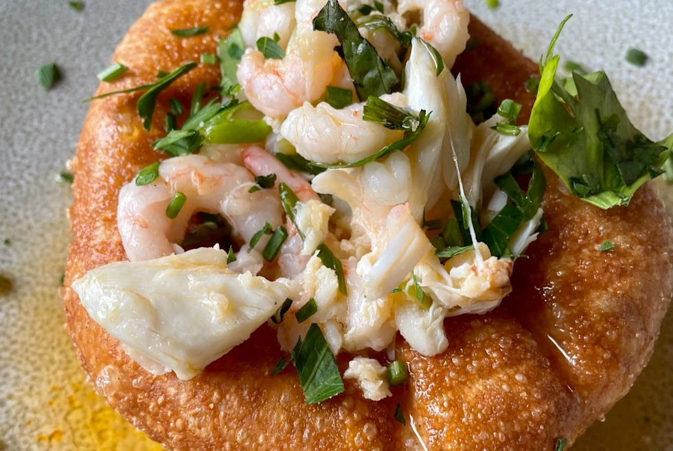 shrimp taco with herbs on a white plate