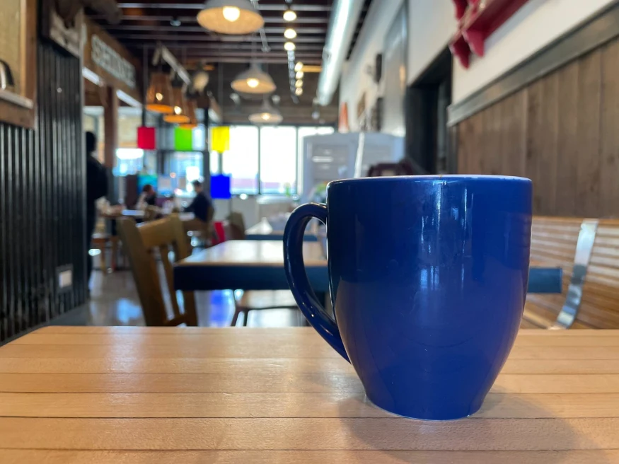 a blue coffee mug in a cafe