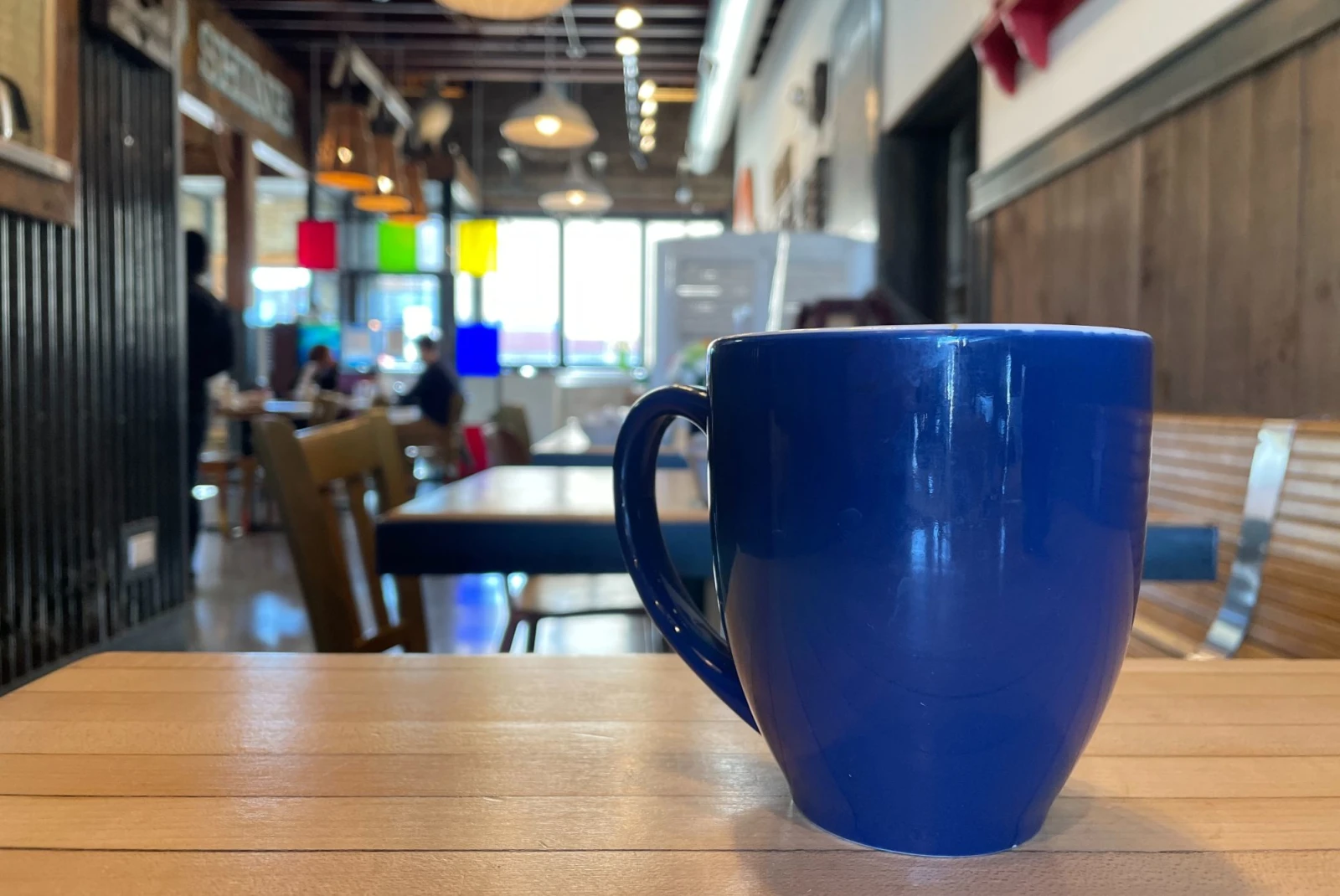 a blue coffee mug in a cafe