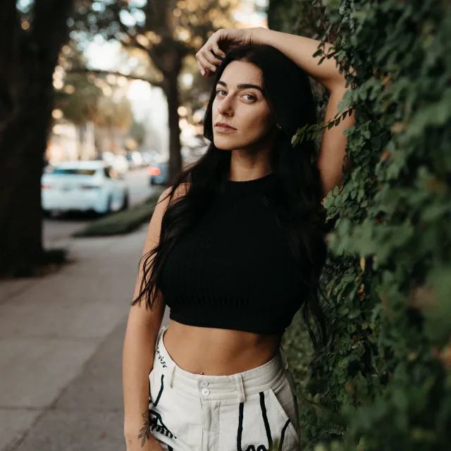 Ashley Lauren Cox posing in a black top