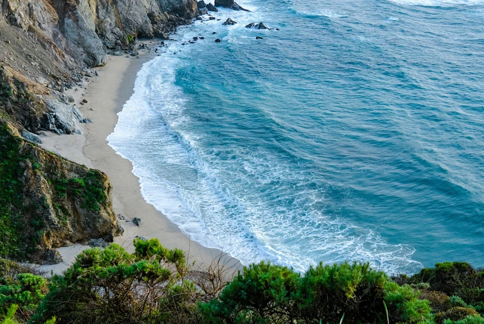 aerial view of a bay of blue ocean water