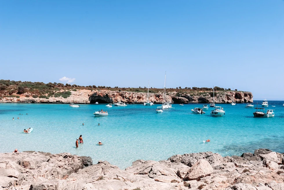 Beach with people and boats. 