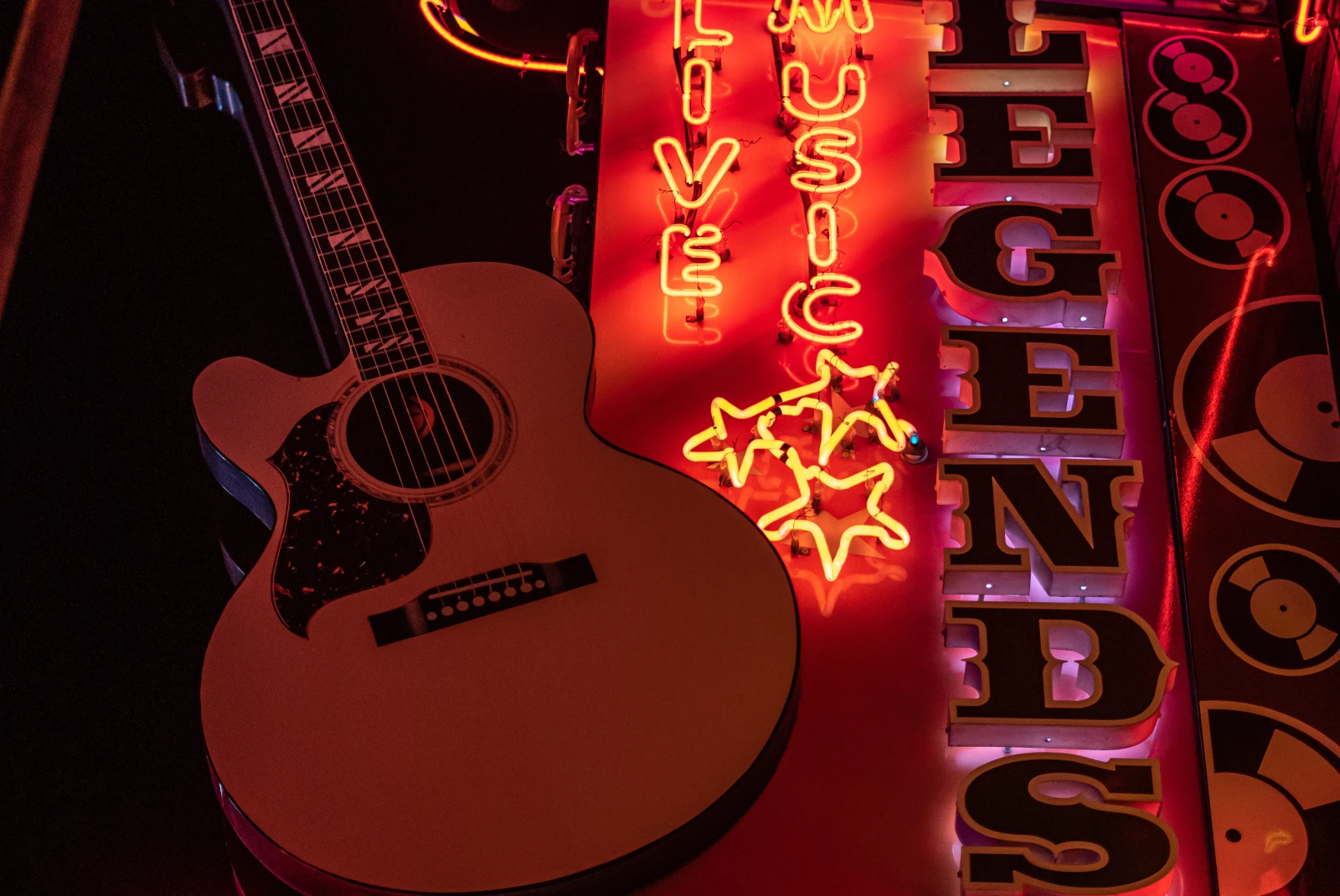 Neon sign with a guitar at night
