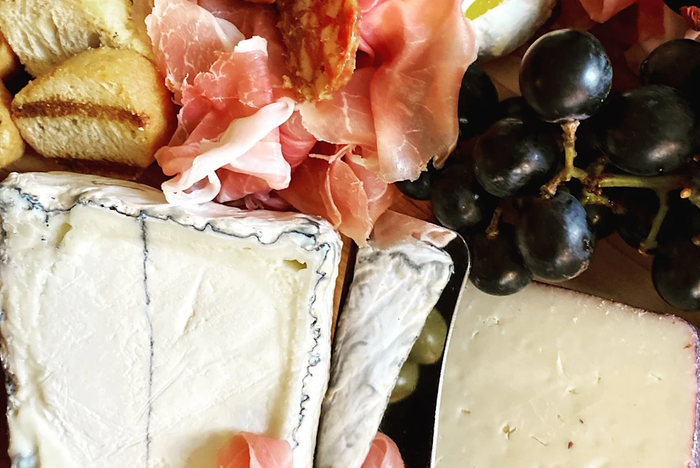plate of cheese, meat and crackers