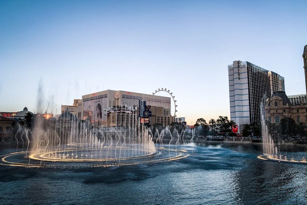 Fountain with buildings in the background during sunset