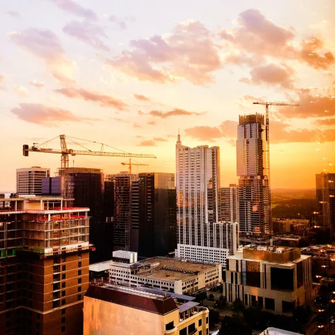 sunset over modern city reflects on skyscrapers