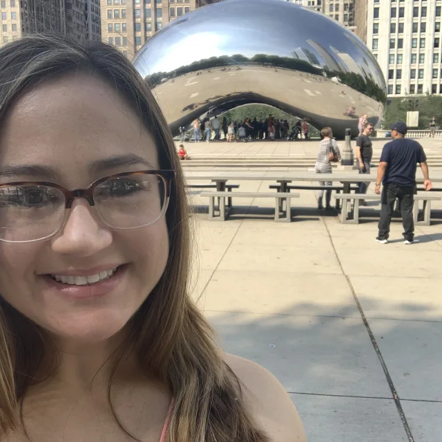 Fora travel agent Aimee Barbier standing in front of the Chicago Bean