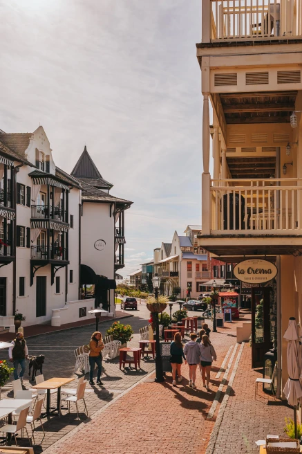 Storefronts and tables on the street with buildings in Rosemary Beach, FL