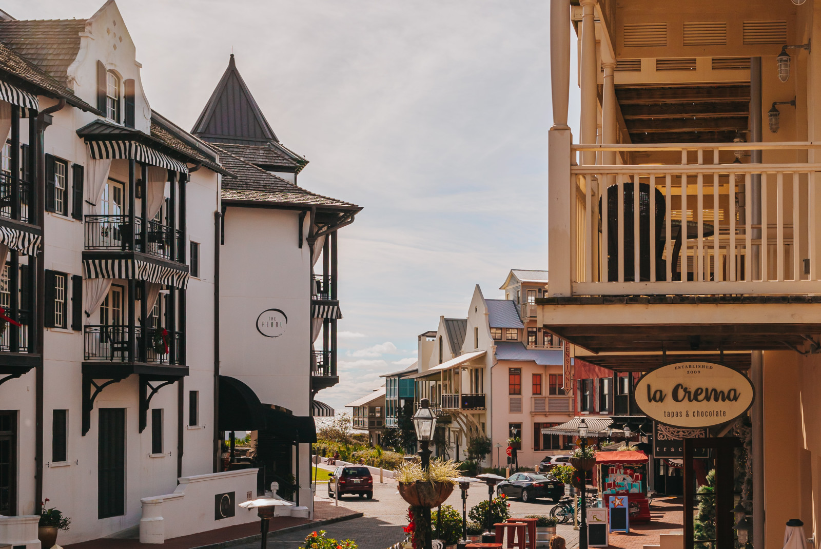 Storefronts and tables on the street with buildings in Rosemary Beach, FL