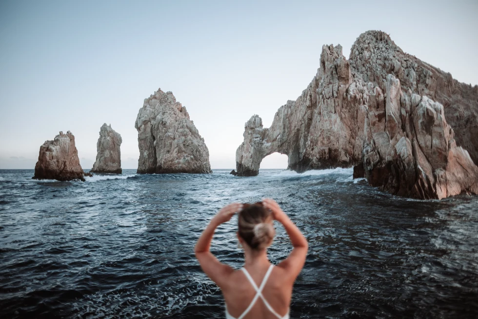 A girl taken a photo of the rock formation in Los Cabos. 