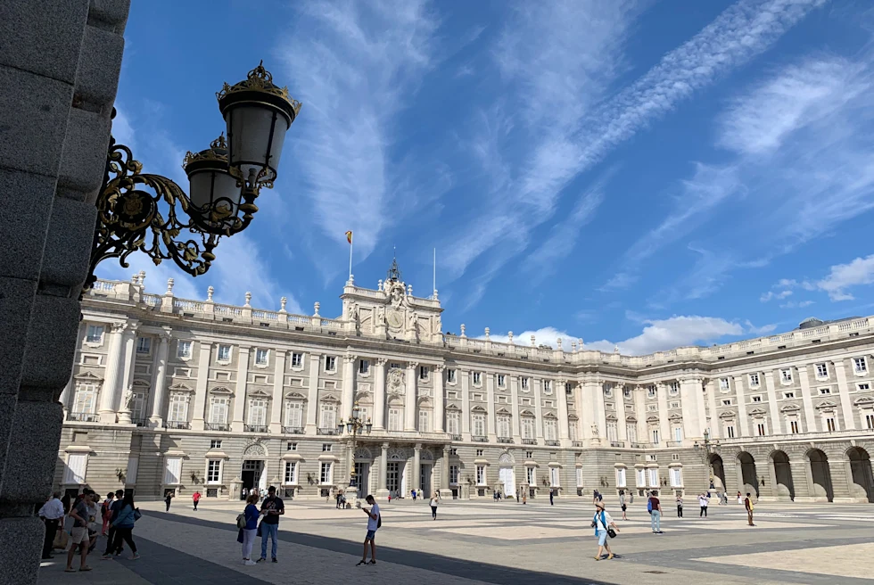 People walking next to large white building during daytime