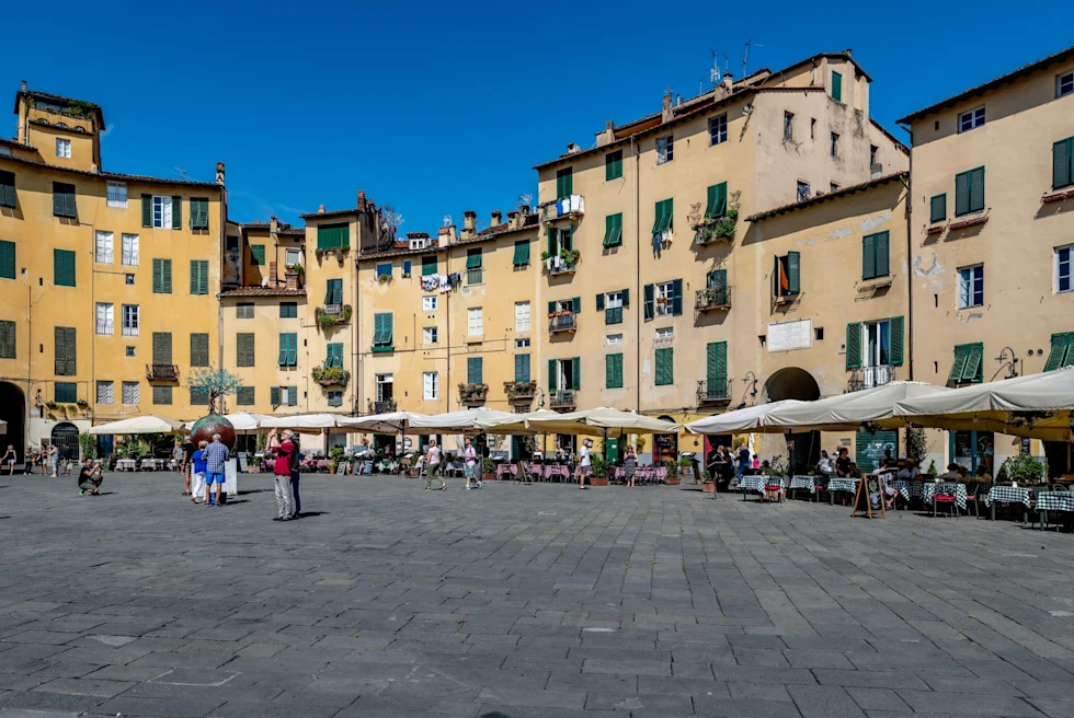 square with yellow buildings and outdoor dining