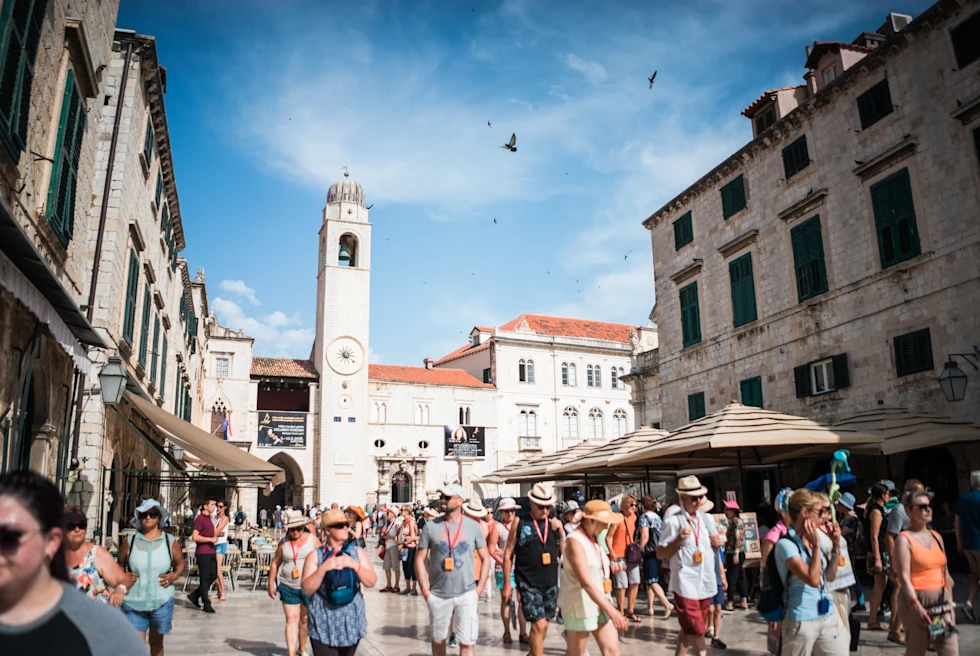 bustling historic village during the day with church steeple
