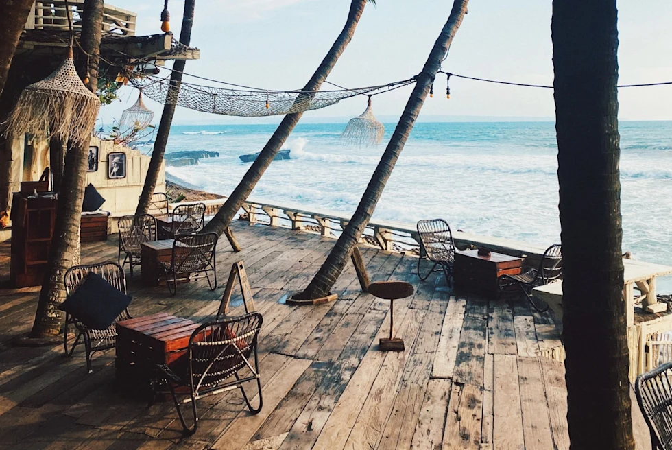 wooden oceanfront deck with palm trees