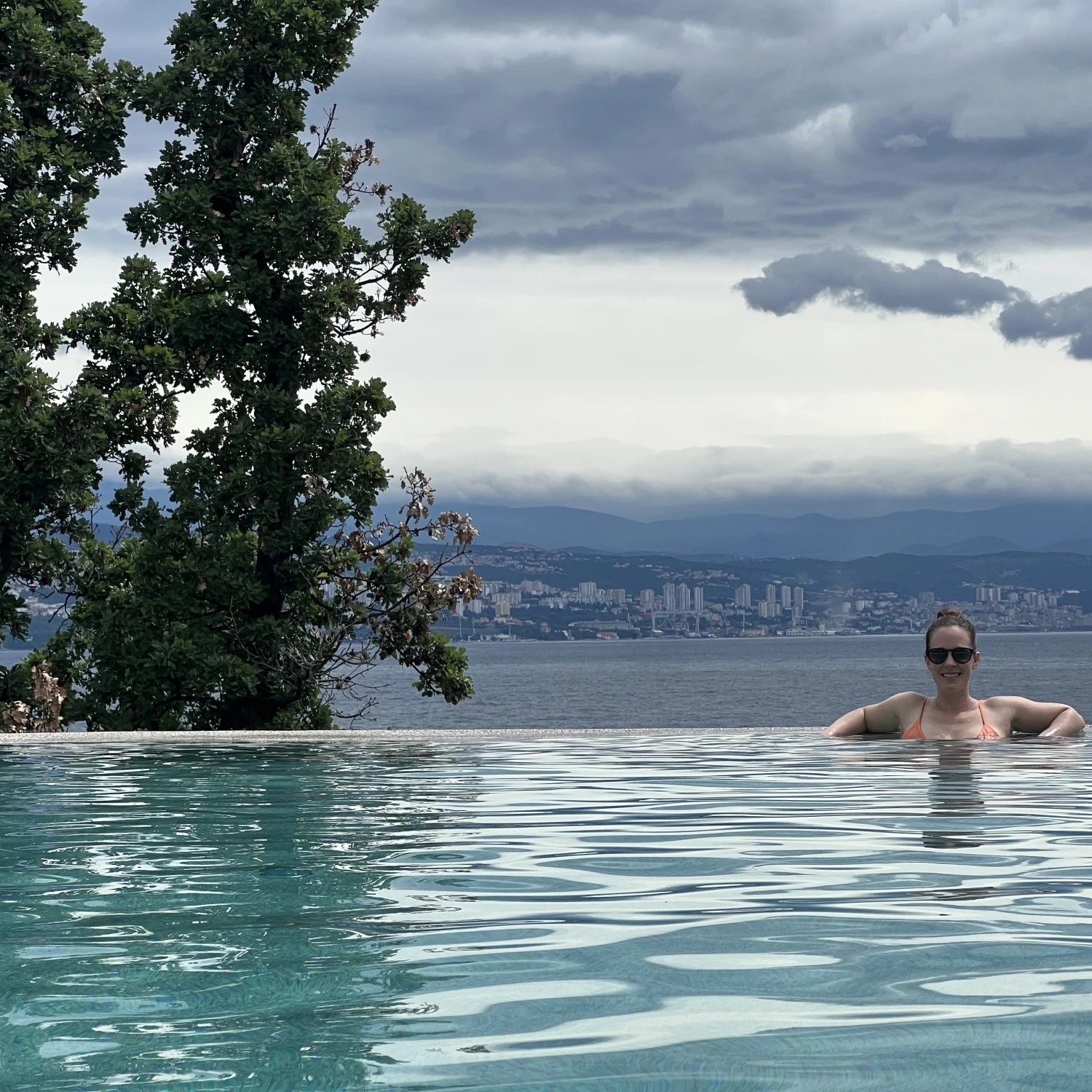 Travel advisor posing in a pool