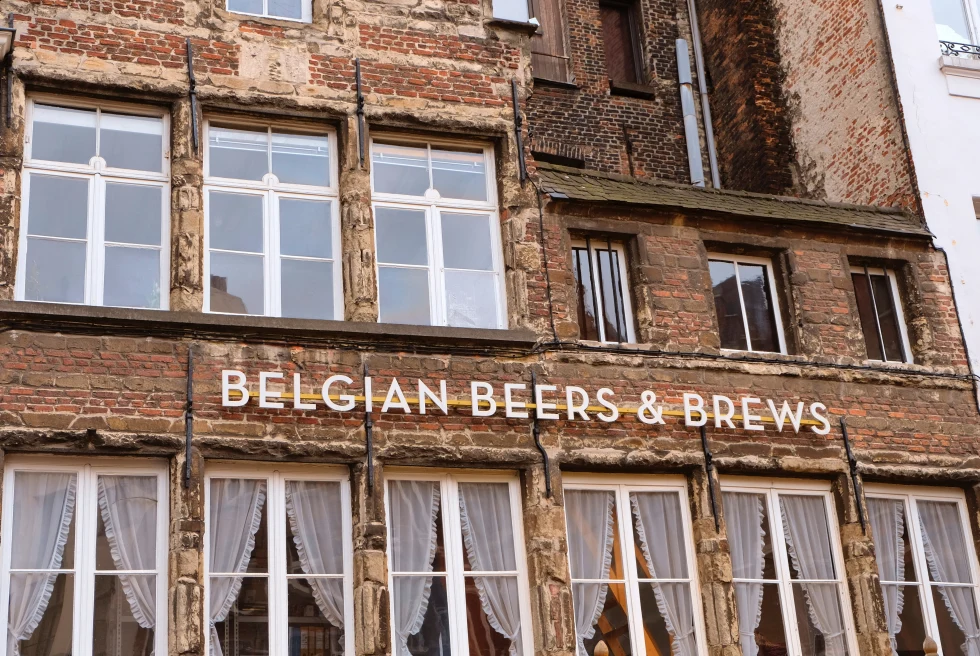 Belgian beer sign on a brick building.