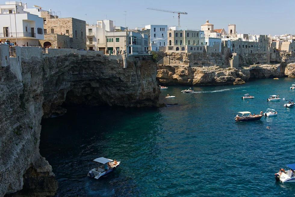 view of a coastal city with blue sky and boats