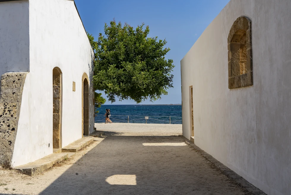 Views of Noto where two walls frame the sea.