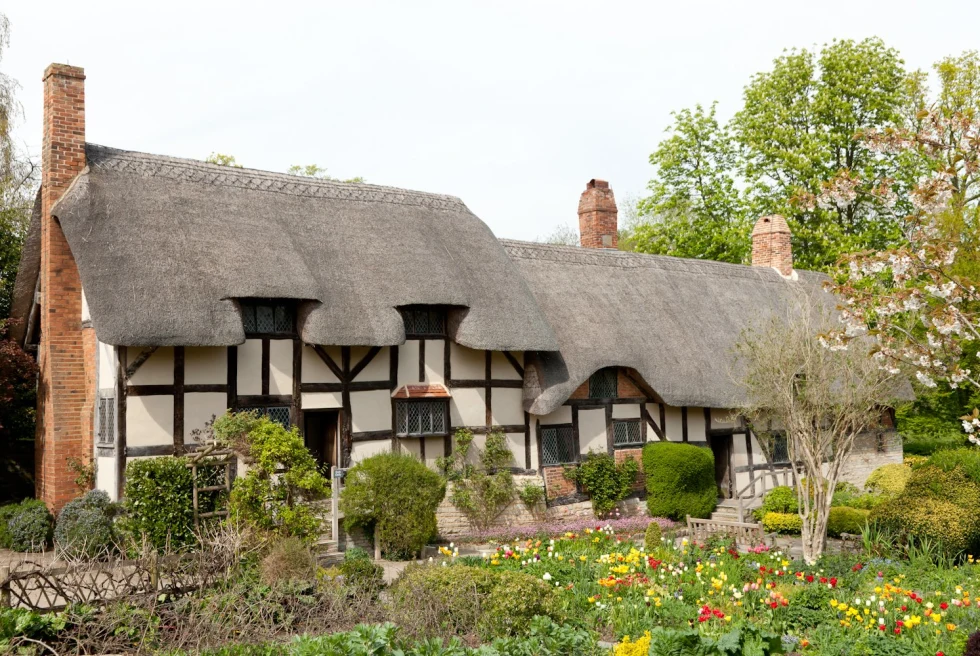 Anne Hathaway's Cottage is a thatched house nestled in an idyllic cottage garden.