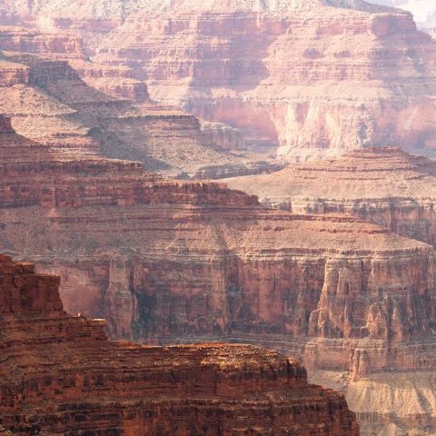 Endless layered rock formations in the Grand Canyon on a bright day. 