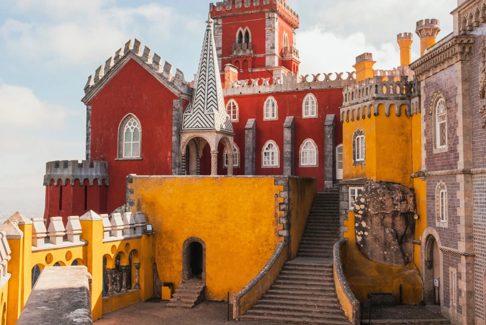 A yellow and rust building which looks like a castle.