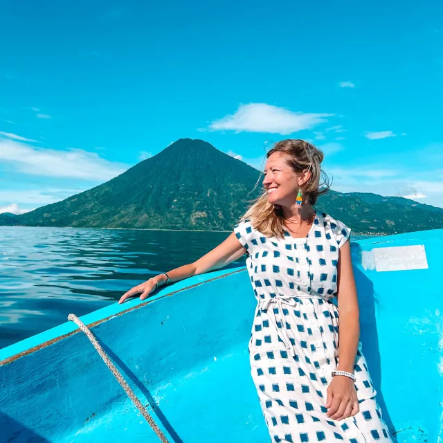 Travel advisor Shannon Riesenfeld on a boat wearing white polka dress.