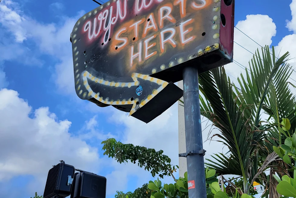 Sign says "Wynwood Starts Here" on a sunny day in Miami