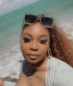 Fora travel agent Shantele Allen wearing sun glasses with ocean in background