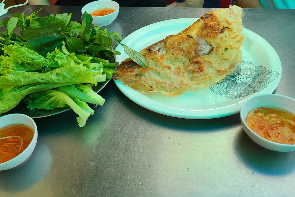 Banh Xeo is a crispy savory Vietnamese crepe, wrapped in herbs, and dipped in fish sauce.
