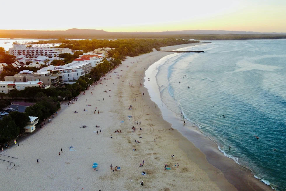 aerial view of beach and ocean during sunset