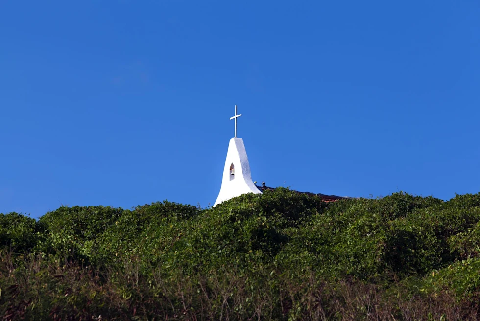 steeple of a church at the top of a tropical island