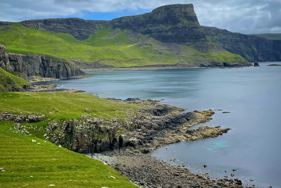body of water next to mountains