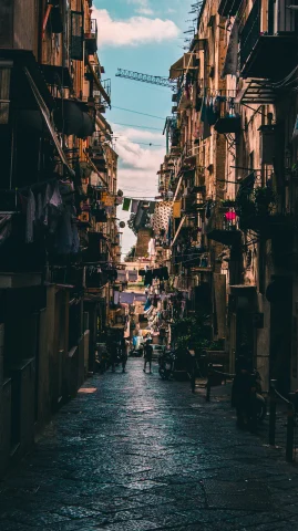 A small street in Naples featuring hanging clothes. 