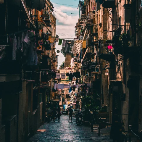 A small street in Naples featuring hanging clothes. 