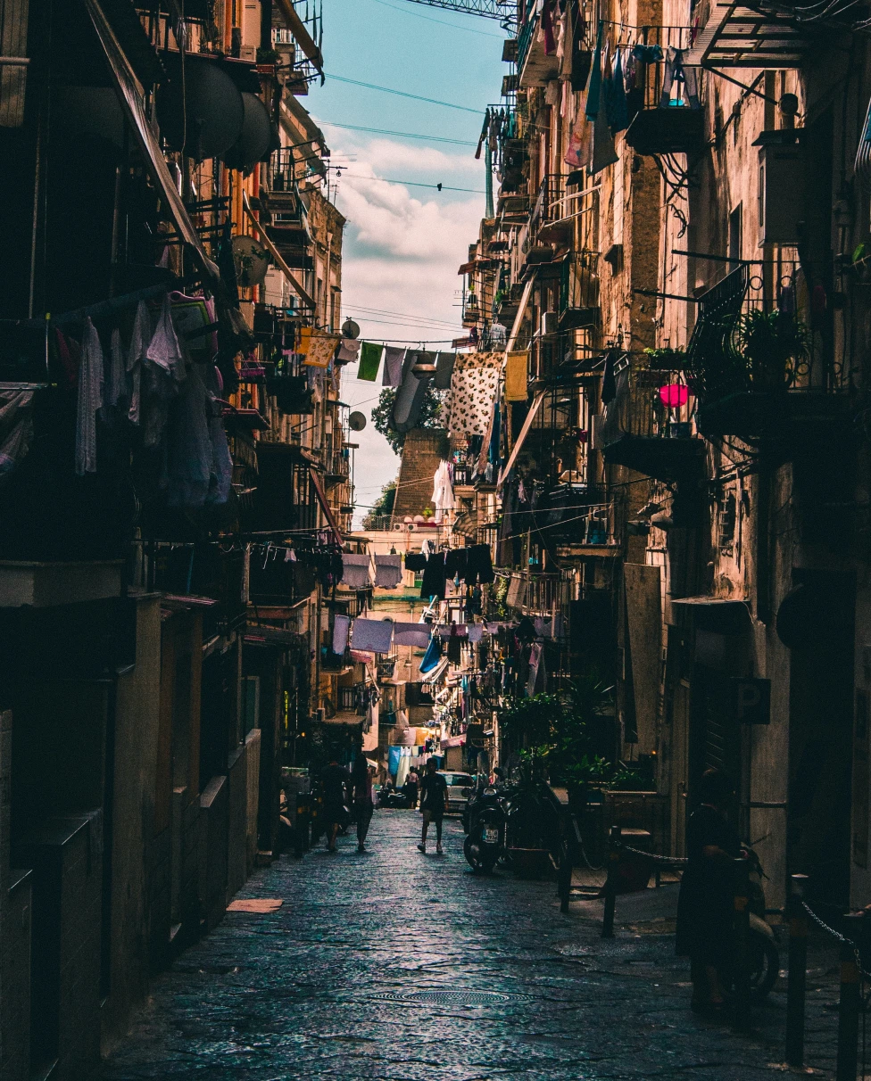 A small street in Naples featuring hanging clothes. 