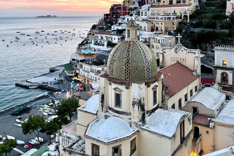 view of an Italian hillside village overlooking the sea