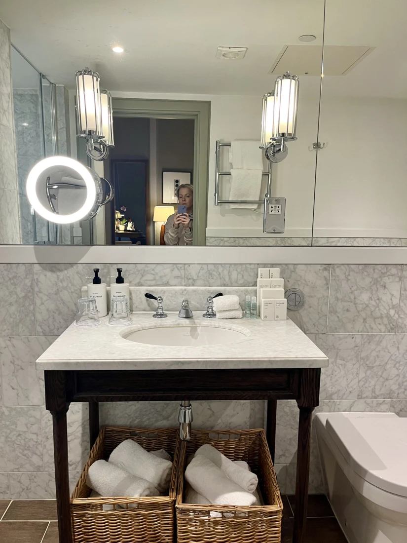 A sink and mirror in a hotel bathroom