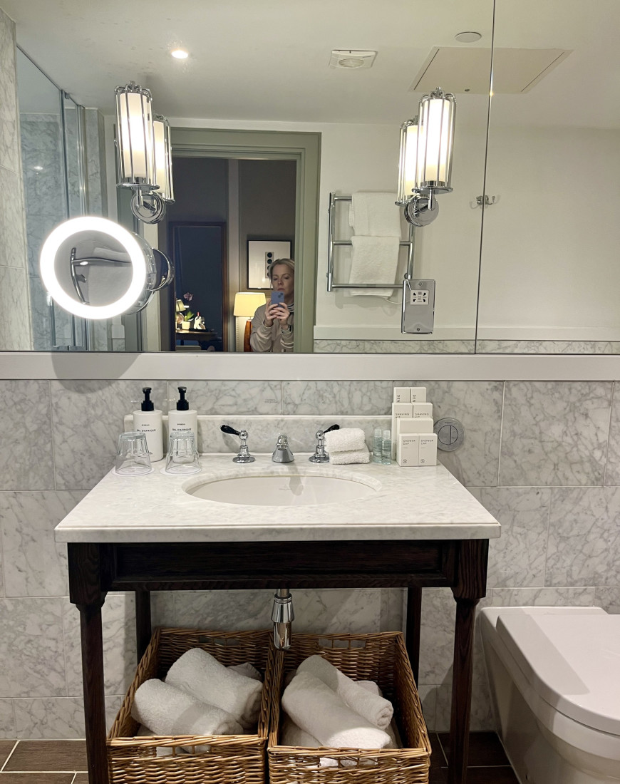 A sink and mirror in a hotel bathroom