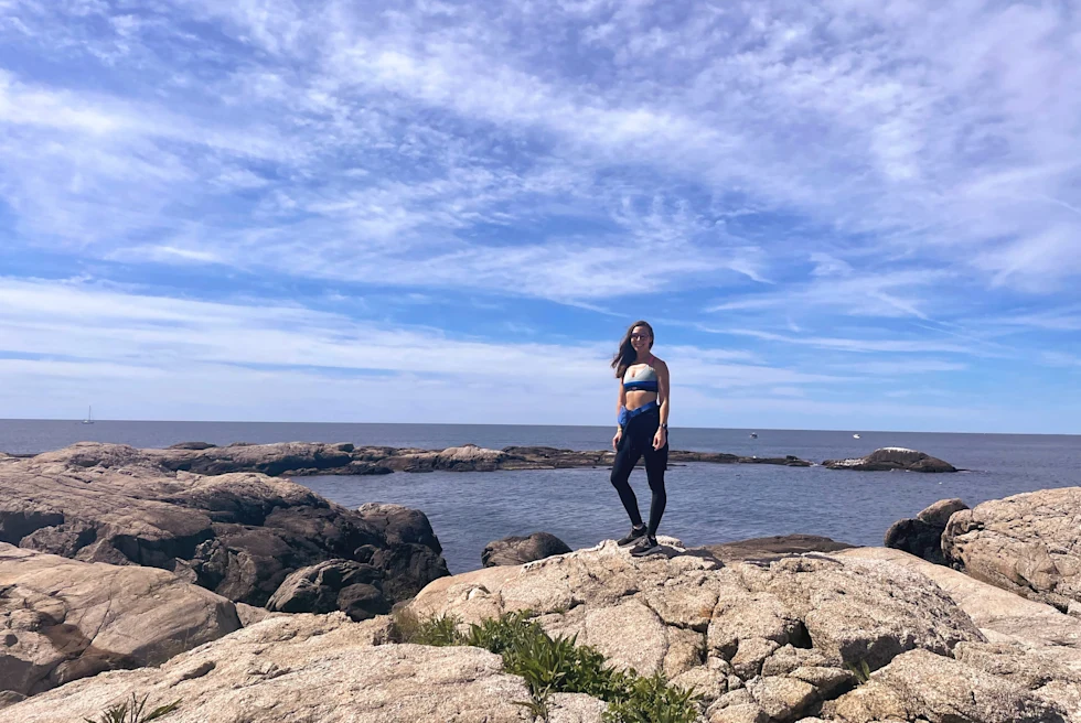 A girl standing on a cliff.