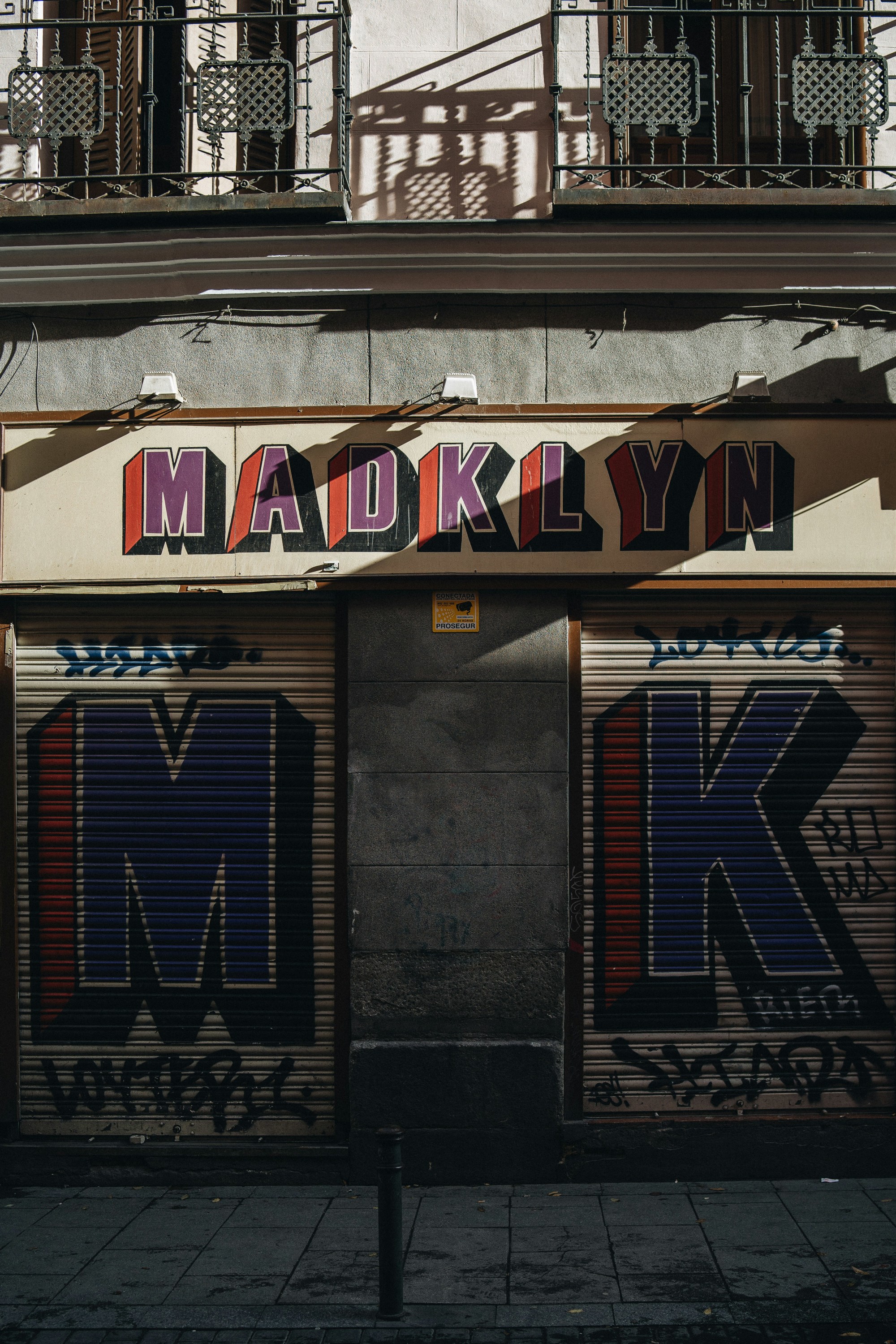 an urban garage façade that reads "Madklyn"