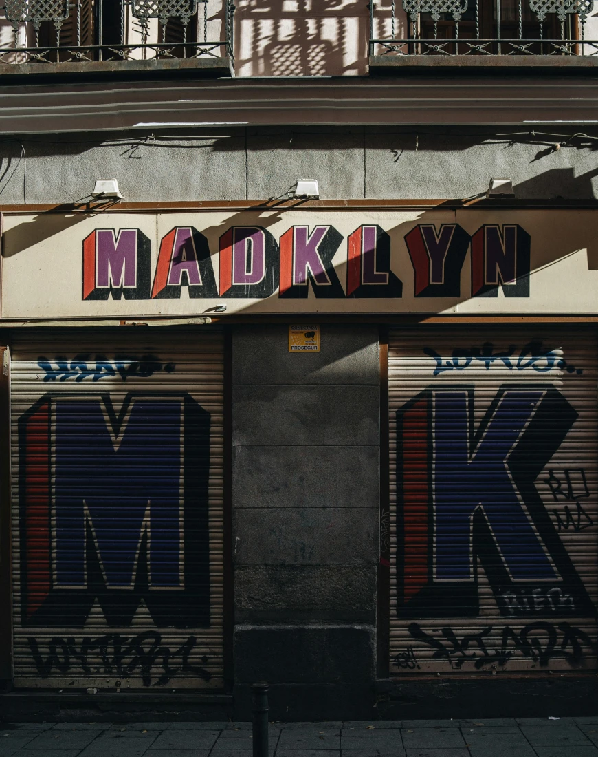 an urban garage façade that reads "Madklyn"