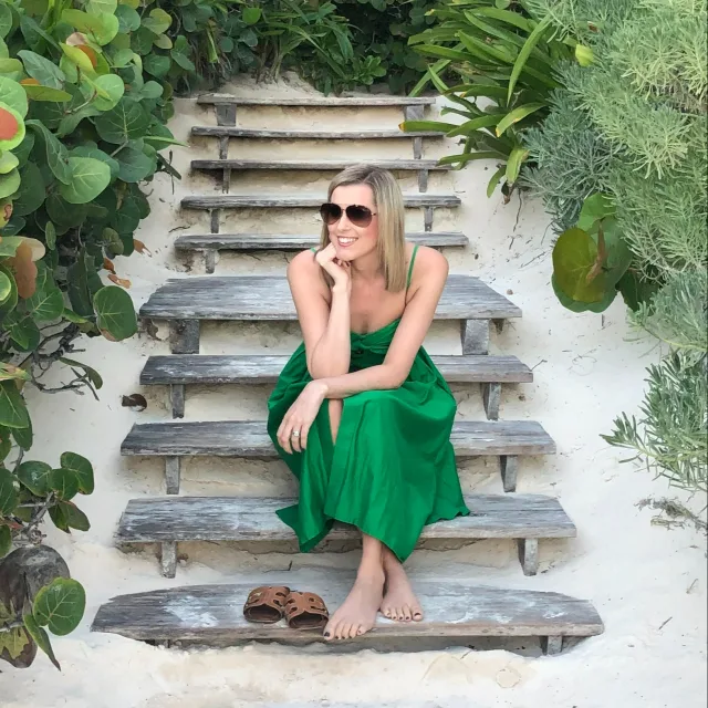 Picture of Allison in green dress sitting on stairs